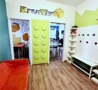 Colorful office interior with wood-patterned flooring and a creative entrance design.