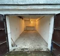 Open garage at Priekopy in Bratislava - Ružinov, with a concrete floor and a front table.