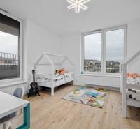 Children's room with two beds, a desk, a carpet, and a floor with a wooden decor.