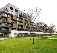 Apartment complex on Fialová Street in Bratislava - Petržalka with manicured lawn and benches.