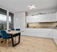 Kitchen corner with dining table in a 3-room apartment, floor with wooden decor.