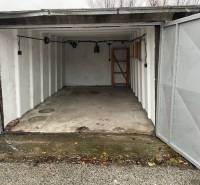 Open garages on Prístavná Street in Bratislava - Ružinov with a bare concrete floor.