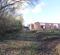 An unfinished family house on Drieňová Street in Nitra surrounded by trees and nature.