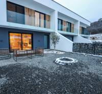 The exterior of a family house on Modrovka Street, Modrovka, with stone pathways and a terrace.