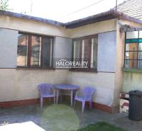 Family house in Trnava, outdoor yard with a plastic table and chairs, flower pot.