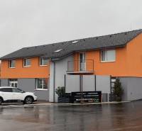 Building on Štúrova Street in Nitra with commercial spaces and a parked car.