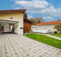 Family house on Školská Street in Senec with a garage, paving, and a garden.