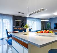 Living room in a family house with a kitchen island, sofa, and dining table.