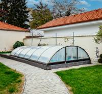 A swimming pool with a cover in the garden of a family house on Školská Street in Senec.