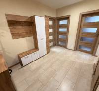 An entrance hall with wooden furniture and a floor with a wood decor in a 4-room apartment.