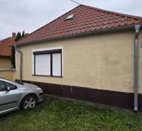 A family house on Hlavná Street in Veľká Mača with a car on the lawn.