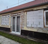A family house on Hlavná Street in Veľká Mača with an unfinished facade and a red roof.