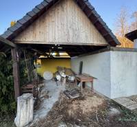 A shelter by the family house in Demandice, old wood and tools in the yard.