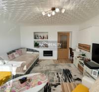 Living room with a comfortable sofa in a two-room apartment, floor with wooden decor.