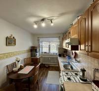 Kitchen with dining area, wooden decor flooring, 2-room apartment.