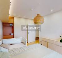 Children's room with a bed, a rattan lamp, and a wardrobe in a 3-room apartment.