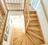 A staircase with a wooden decor and railing in a family house.