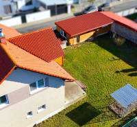 A family house in Lipany on Rovinky with a sloped roof and a yard with a shelter.