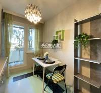 Dining area with a small table and chairs in a 3-room apartment.