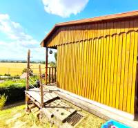 A picturesque wooden cabin with a view of the scenic countryside, ideal for relaxation and escape.