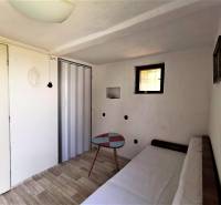 The cabin features a cozy room with a couch, a table, and wooden flooring.