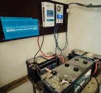 Batteries and inverter in the technical room of the cottage, showing electrical installation and power supply.