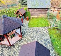 Garden gazebos near the Cottage in Partizánske are surrounded by greenery and paved walkways.