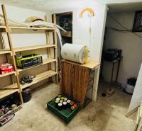 Storage space in a cabin with shelves and various tools and appliances.