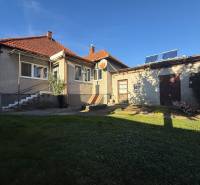 A family house in Machulince with a garden and an annex, on a sunny day with a blue sky.