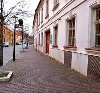 Františkánska Street in Trnava with the Office building and trees along the sidewalk.
