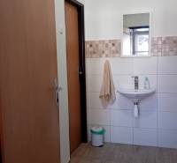 Offices with a sink, mirror, and floor with wood decor.