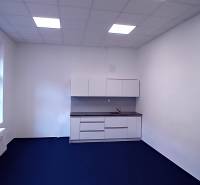 Offices with blue flooring and a kitchen unit.