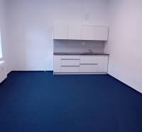 Offices with white cabinets and blue carpet on Františkánska Street in Trnava.