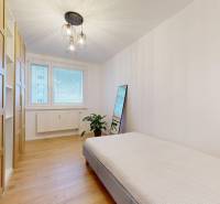 A bedroom with wood-decor flooring, a bed, and a wardrobe in a 3-room apartment.