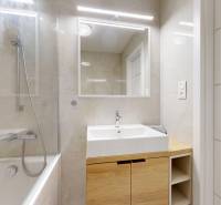 Bathroom with a bathtub, sink, and mirror in a 3-room apartment. Elegant design.