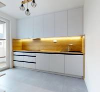 A kitchen in a 3-room apartment with wooden decor and light furnishings.