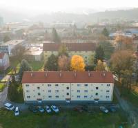 A view of apartment buildings on Tarasa Shevchenko Street in Prešov, surrounded by greenery.