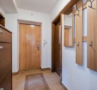 Entrance hallway in a 2-room apartment with tiles and coat hooks.