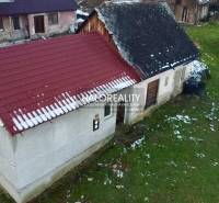 A family house in Klenovec, shown with a gabled roof and a snow-covered garden.