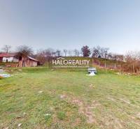 A spacious plot near a family house in Klenovec with a grassy area and smaller structures.