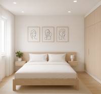 A bedroom with a double bed, wooden decor flooring, and minimalist illustrations on the walls.