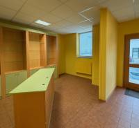 Commercial space with shelves, a counter, and tiling, ideal for various business purposes.