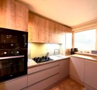 A kitchen with wooden decor, built-in appliances in a 3-room apartment.