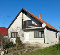 A family house on Podzáhradná Street in Iža with a front garden, balcony, and satellite dish.
