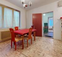 Dining room with a dining table and chairs, floor with wood decor, family house.