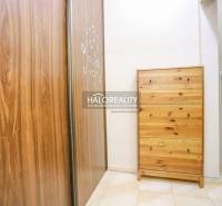 A hallway with a wardrobe and a chest of drawers in a 2-room apartment with tiles.