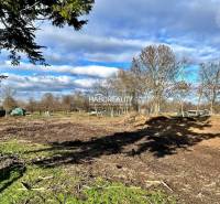 Plots - housing in Ondrejovce with grassy area, trees, and open sky.