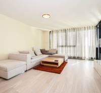 Living room in a 3-room apartment with a corner sofa, a coffee table, and a wooden decor floor.