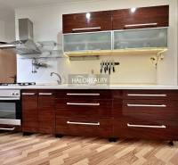A kitchen in a 3-room apartment with a kitchen unit and a wooden decor floor.