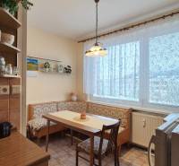 A kitchen corner with a corner bench in a 2-room apartment, floor with a wooden decor.